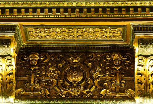 an ornate gold design on the wall of a building at Hotel 5 Continents in Craiova