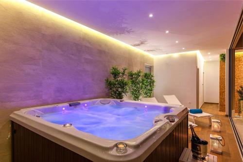 a jacuzzi tub in a bathroom with purple lighting at Villa Sea Breeze in Split