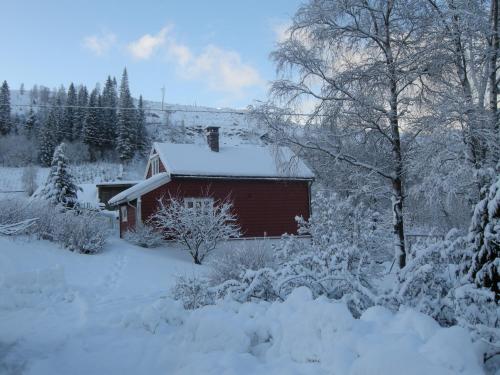 a shed covered in snow in a yard at Skjerping gård in Lonevåg