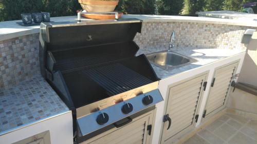 a kitchen with a stove and a sink at Villa UNIDERA in Kouklia