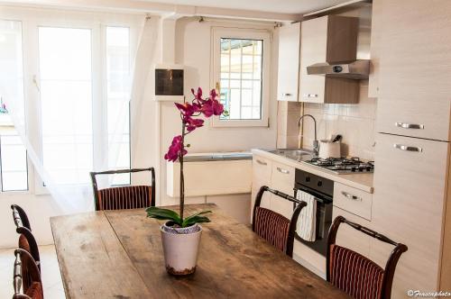 a kitchen with a wooden table with a plant on it at Liberty House in Bologna