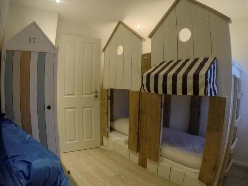 a room with four bunk beds in it at Hotel Stadt Cuxhaven in Cuxhaven