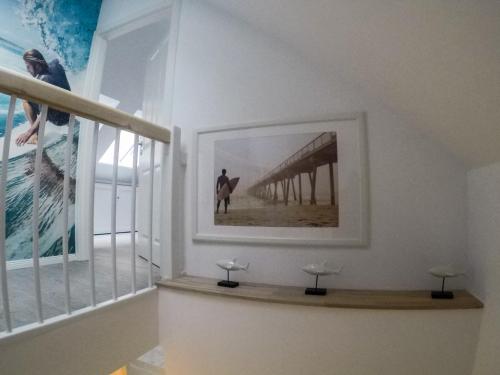 a hallway with a picture of a surfer and a window at Hotel Stadt Cuxhaven in Cuxhaven