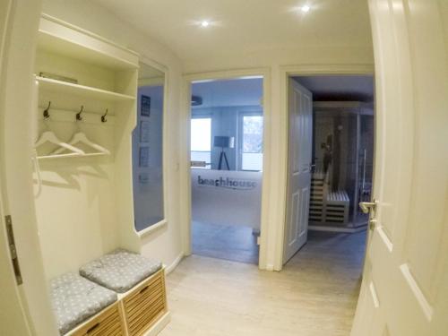a hallway with a walk in closet with a bench at Hotel Stadt Cuxhaven in Cuxhaven