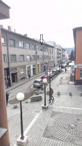 a city street with street lights and a building at Stan na dan Banja Luka in Banja Luka