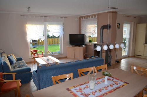 a living room with a blue couch and a table at FH Bernstein_CuE in Ostseebad Karlshagen