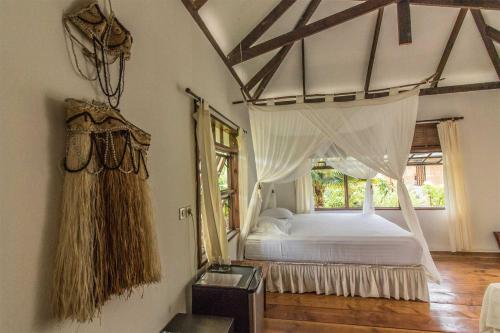 Tempat tidur dalam kamar di Le Coconut Lodge