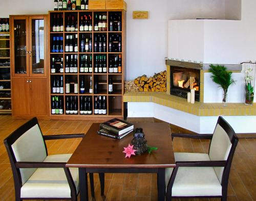 a living room with a table and a fireplace at DAS TANN rooms & wine in Thale