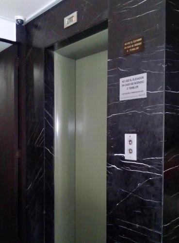 a elevator in a building with a sign on the wall at Residencias Señorial in Mexico City