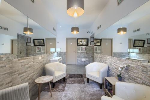 a salon with white chairs and a waiting room at Vatican Treasure in Rome