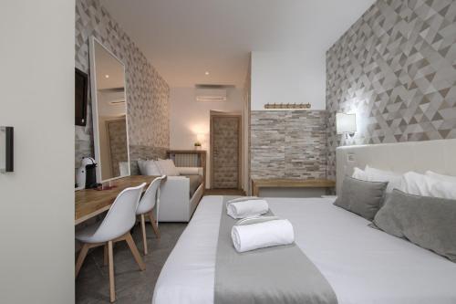 a bedroom with a large white bed and a living room at Vatican Treasure in Rome