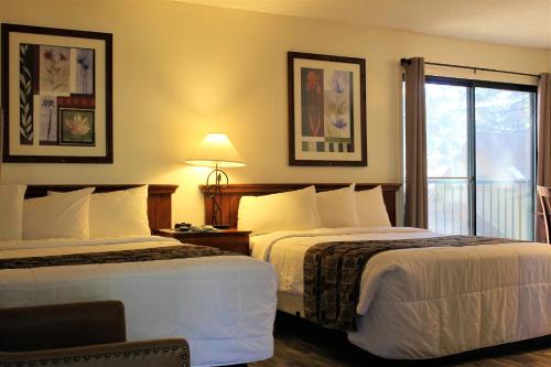 a hotel room with two beds and a balcony at Big Pines Mountain House in South Lake Tahoe