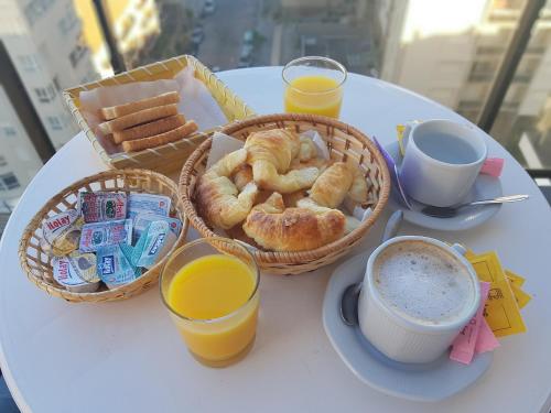 a table with two baskets of bread and two cups of coffee at Club Sol Mar Del Plata in Mar del Plata