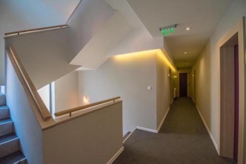 an empty hallway with a staircase in a building at Hotel Nova Bentbaša in Sarajevo