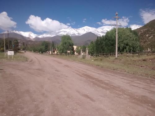 a dirt road with snow capped mountains in the background at Casa de montaña, valle del sol, potrerillos, Mendoza in Mendoza