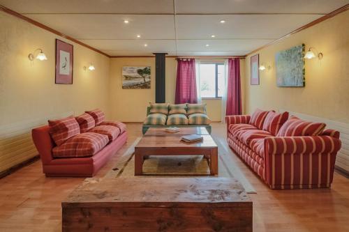 a living room with two couches and a coffee table at Hotel Saltos del Paine in Puerto Natales