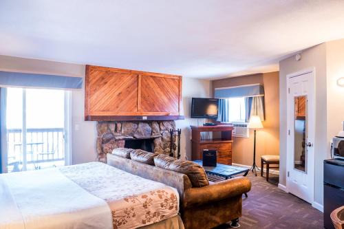 a hotel room with a bed and a fireplace at Murphy's River Lodge in Estes Park