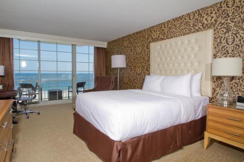 A bed or beds in a room at Ocean Club Hotel