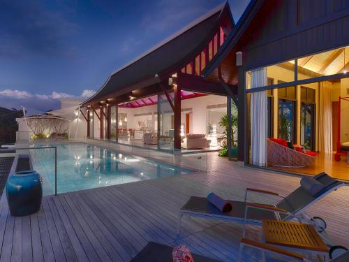 a house with a swimming pool on a wooden deck at Malaiwana Villas in Nai Thon Beach