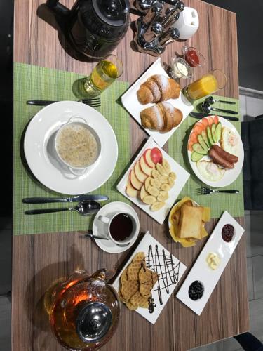 a table with plates of food on a table at MAXX inn in Astana