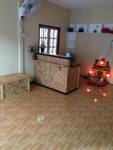 a living room with a counter and a wooden floor at Anya House in Thongsala