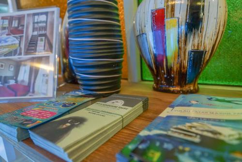 a book sitting on a table next to a vase at Destini Akef Villa in Pantai Cenang