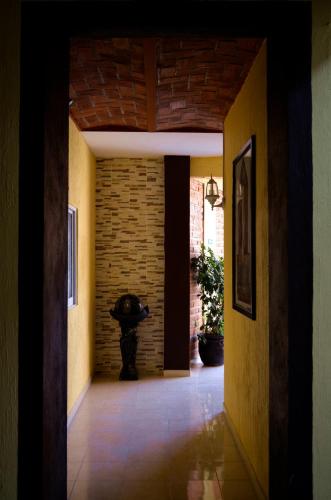 a hallway of a house with a brick wall at Hotel Gesa in Villa Corona