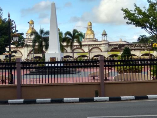 a fence with a monument in front of a building at D'Perdana Apartment 2 in Kota Bharu