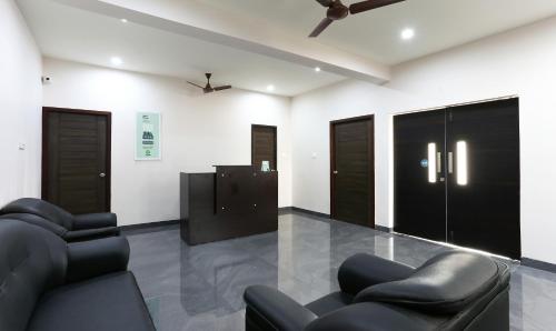 a waiting room with two chairs and a television at Treebo Hi Line Apartments Kalapatti in Coimbatore