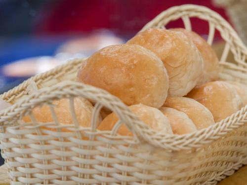 a basket full of bread sitting on a table at Hotel101 - Manila in Manila