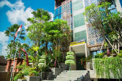 a building with stairs and trees in front of it at MaxOneHotels at Ubud - CHSE Certified in Ubud