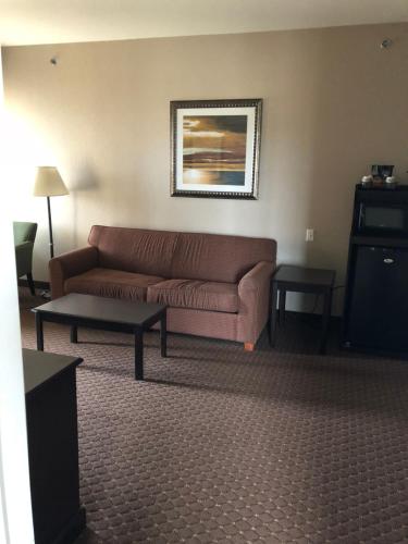 a living room with a couch and a table at Americas Best Value Inn - Gun Barrel City in Gun Barrel City