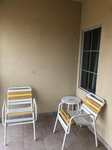 two chairs sitting on a porch next to a window at Americas Best Value Inn - Gun Barrel City in Gun Barrel City