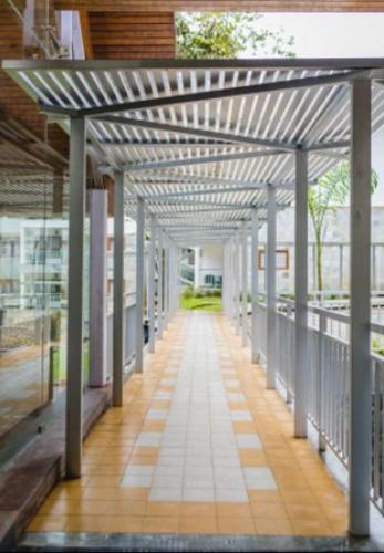 an empty hallway of a building with awning at Elixir Hills Suites Resort and Spa in Munnar