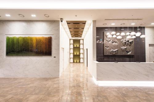 a lobby with a large painting on the wall at ENA Suite Hotel Namdaemun in Seoul
