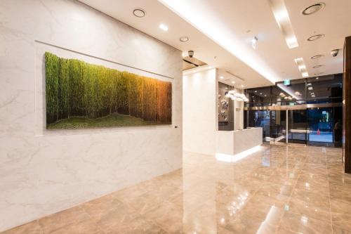 a lobby with a large painting on the wall at ENA Suite Hotel Namdaemun in Seoul