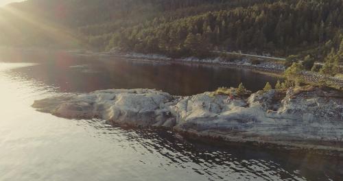 an island in the middle of a body of water at Tustna Ladestasjon in Hals