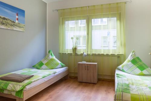 a bedroom with two beds and a window with a lighthouse at Apartment Wideystrasse in Witten