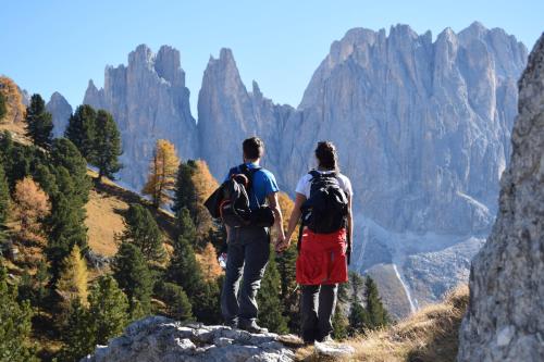 two people standing on a mountain looking at the view at Schlossblick in Vols am Schlern