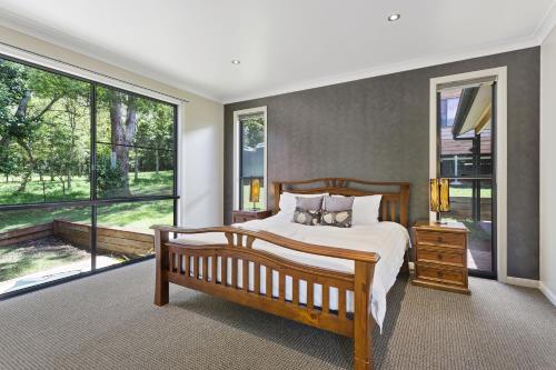 a bedroom with a bed and a large window at Ravensbourne Escape- Rose Alyce in Ravensbourne