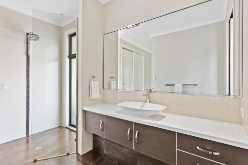 a bathroom with a sink and a mirror at Ravensbourne Escape- Rose Alyce in Ravensbourne