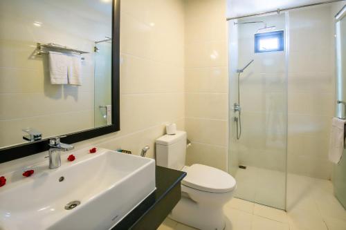 a bathroom with a sink and a toilet and a shower at Ocean Haven Hotel in Da Nang