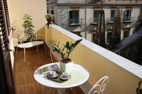 a balcony with a table and chairs on a balcony at B&B Vivere Palermo in Palermo