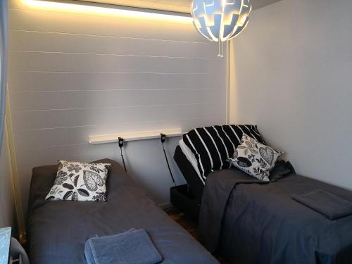 a room with a bed and a couch and a lamp at Motel Tornio in Tornio