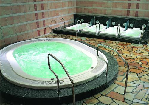 a hot tub in a bathroom with two sinks at GRAND NIKKO AWAJI in Awaji