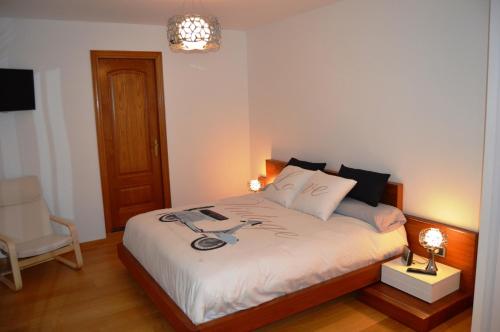 サンタ・クリスティーナ・ダロにあるCasa en la costa Bravaのベッドルーム1室(ランプと椅子付きのベッド1台付)