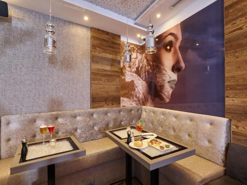 a restaurant with a bench with two plates of food at A-VITA Viktoria & A-VITA living luxury apartments in Seefeld in Tirol