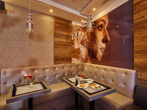 a restaurant with a bench with two plates of food at A-VITA Viktoria & A-VITA living luxury apartments in Seefeld in Tirol