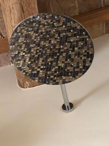 a checkerboard table with a metal stand in a room at Le Case Di San Vitale in Ravenna