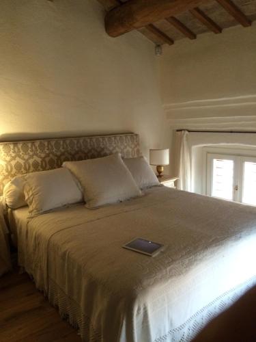 a bedroom with a bed with a laptop on it at Le Case Di San Vitale in Ravenna